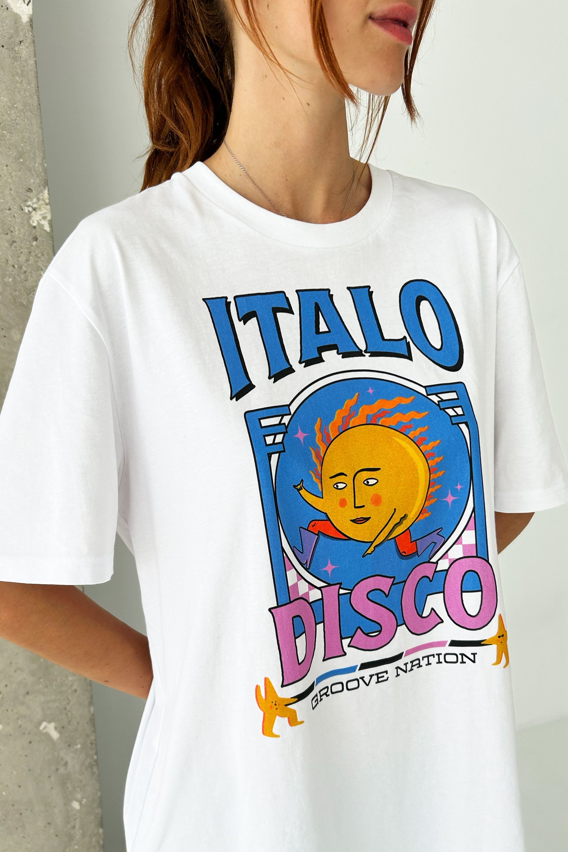 Female Model wearing McIndoe Design's Italo Disco graphic t-shirt in white 100% cotton, close-up cropped image of disco print